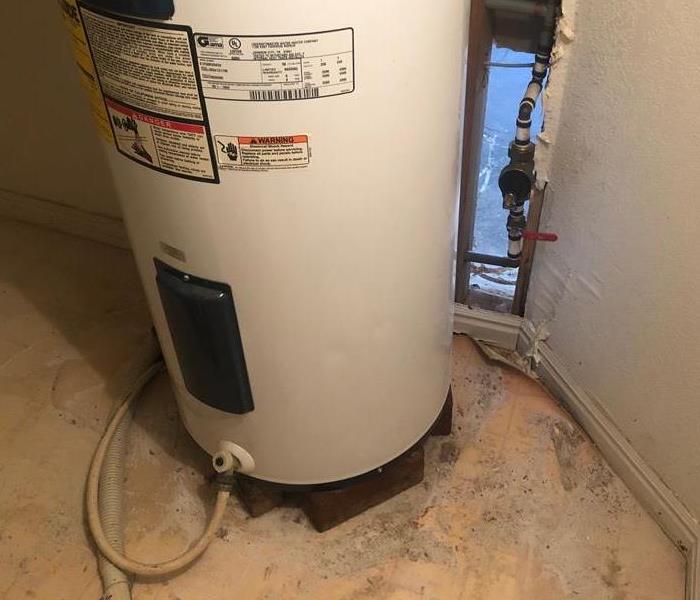 a water heater and exposed pipe