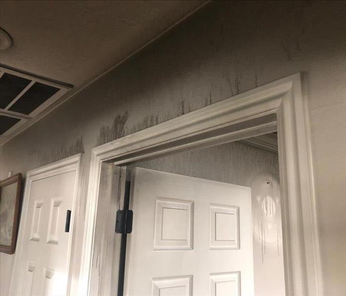 Soot and smoke damage to wall & ceiling.