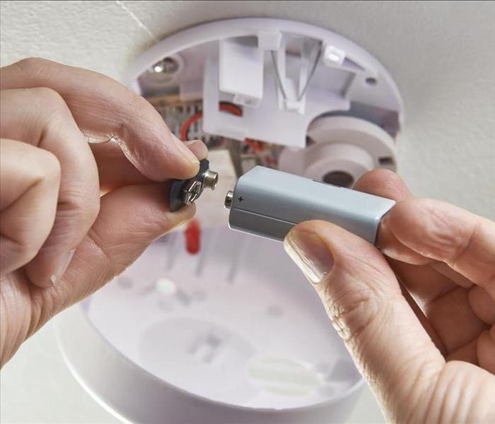 Replacing battery in domestic smoke alarm