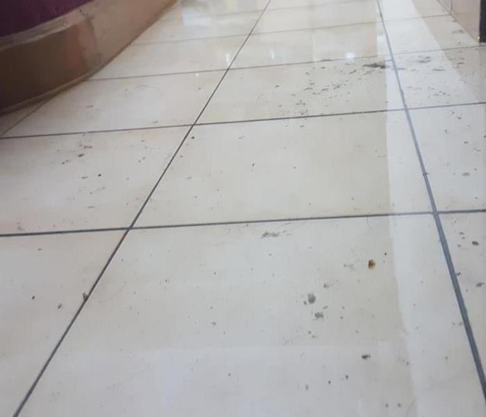 water on tile in a commercial building