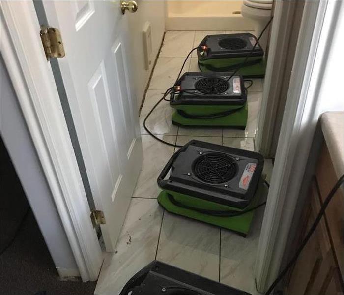 Air movers placed inside a bathroom