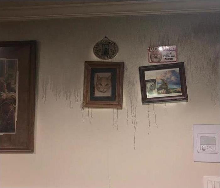 smoke damage on wall, frames hanging